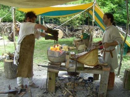 Re-enacters Kormak and Mo hard at work using handmade bellows at their forge